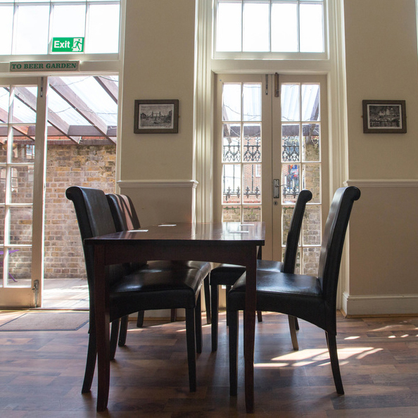 Picture of seats inside the pub by the beer garden door